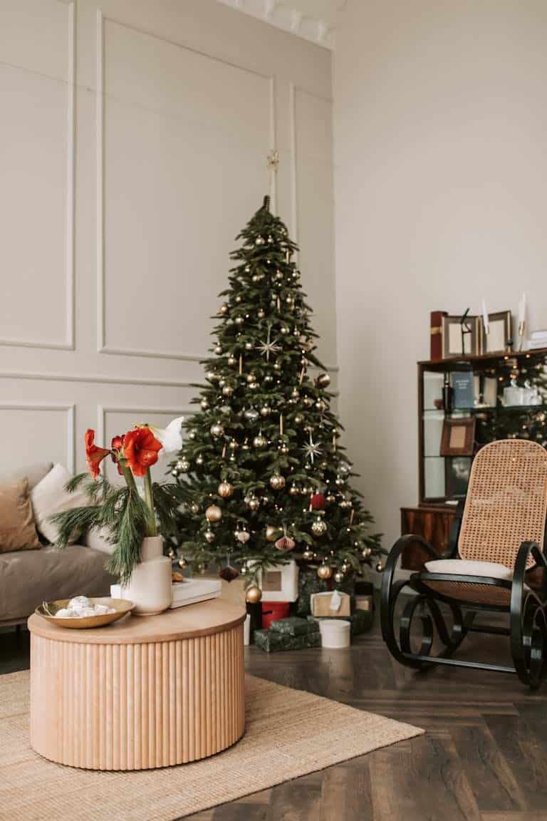 Cozy Christmas-themed living room with a decorated tree, modern furniture, and festive decor.